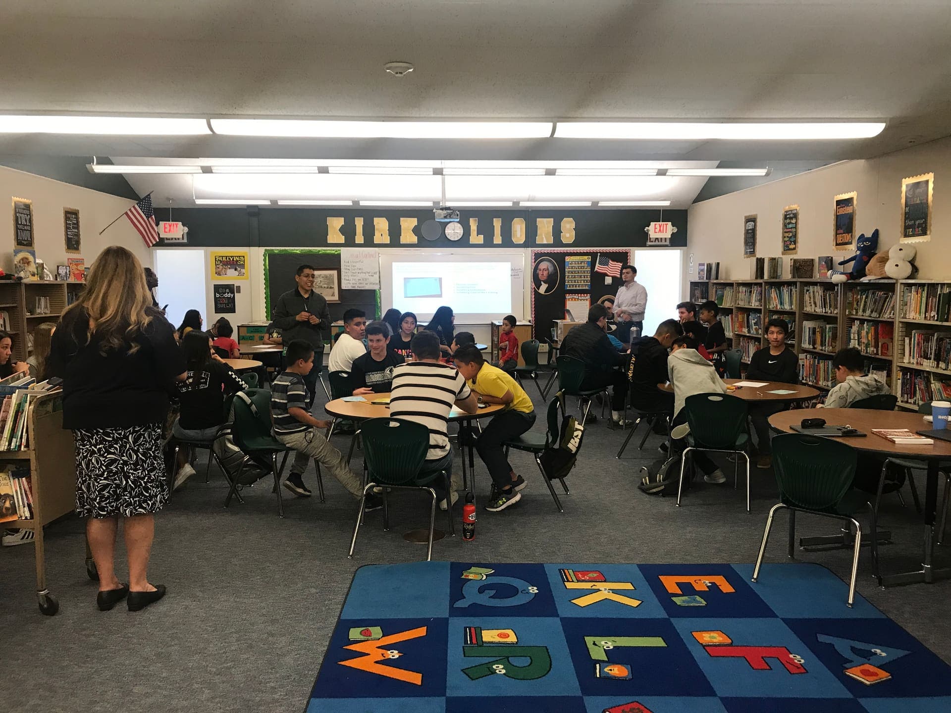 A mentoring session with students in a school library